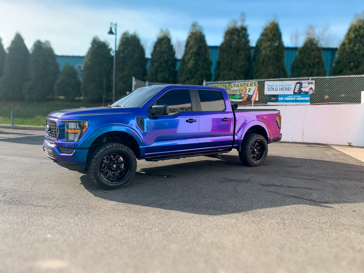 Blue and purple pickup truck with dark tinted side windows for added privacy and UV protection