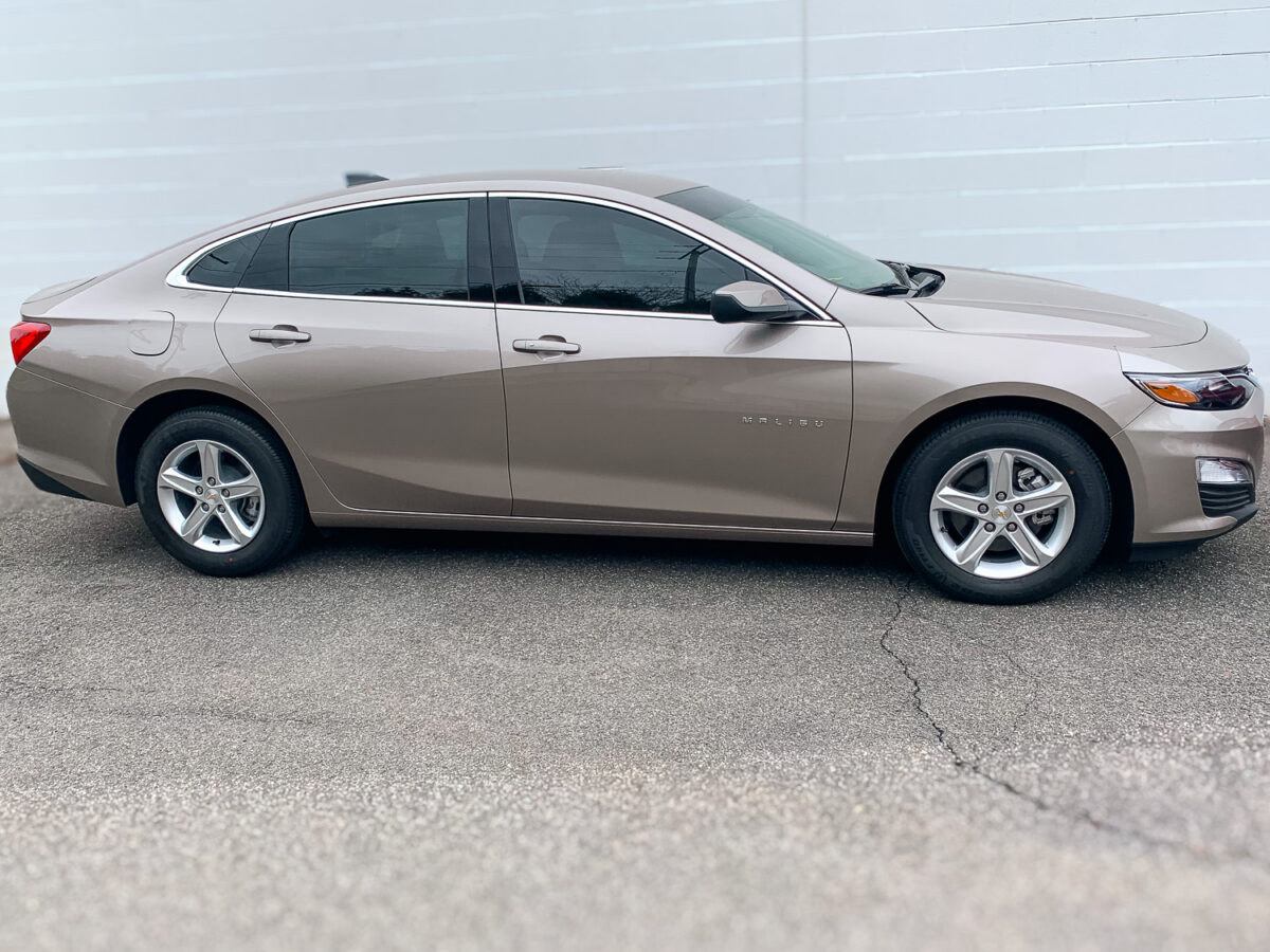 Side view of a sedan with dark window tint on the side and rear glass for added privacy and UV protection.