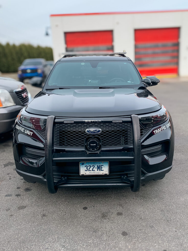 Front view of a black traffic unit SUV with tinted windshield and front side windows for added privacy and UV protection