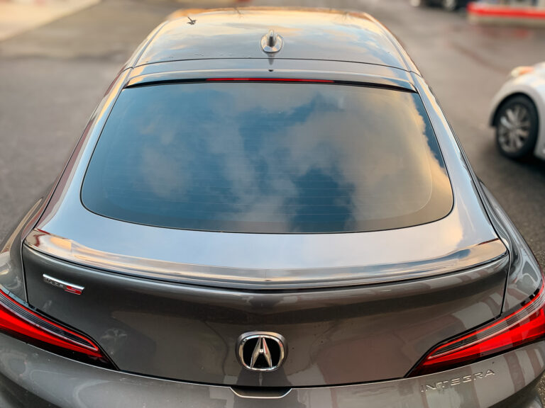 Rear view of an Acura Integra with dark tinted back glass